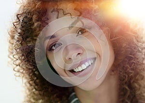 Close-up face of beautiful young woman with curly hair