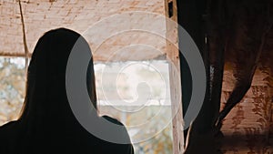 Close up face of Blind Asian woman with black hair and white eyes in front of her house