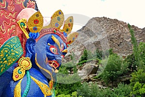 Close Up on face of Blue Mahakala statue in small village in Ladakh, Mahakala is a deity common to Hinduism, Buddhism and Sikhism.