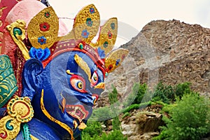 Close Up on face of Blue Mahakala statue in small village in Ladakh, Mahakala is a deity common to Hinduism, Buddhism and Sikhism.