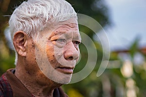 Close-up of face elderly man smiling. Space for text. Concept of aged people and healthcare