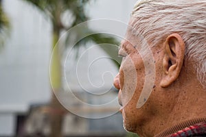 Close-up of face elderly man smiling. Space for text. Concept of aged people and healthcare