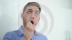 Close-up face of handsome young man taking swab sample of mouth with cotton stick for DNA tests, COVID-19, to determine