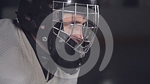 Close-up face hockey goalie. Hockey goalkeeper is on the gate waiting for the opponent