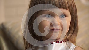 Close-up face of a little girl with big blue eyes