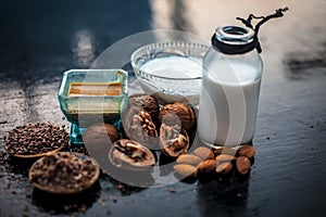 Close up of face mask or face pack of walnut along with flax seed or alsi, almonds,yogurt and milk in a glass bowl   entire raw in