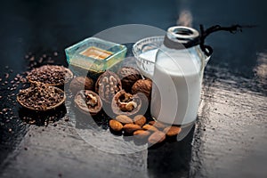 Close up of face mask or face pack of walnut along with flax seed or alsi, almonds,yogurt and milk in a glass bowl   entire raw in