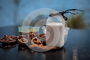 Close up of face mask or face pack of walnut along with flax seed or alsi, almonds,yogurt and milk in a glass bowl   entire raw in