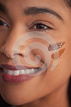 Close up face of mixed race woman with foundation on cheek