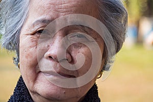 Close-up of face senior woman smiling and looking at the camera. Concept of aged people and healthcare