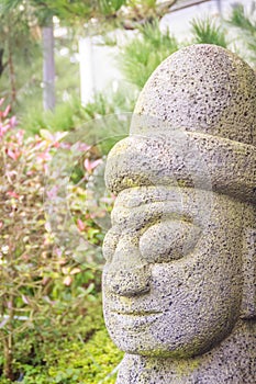 Close up face of the stone idol Dolharubang