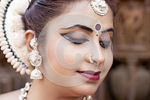 Close up face View of Beautiful indian odissi Dancer in traditional clothing with make-up and jewelry.