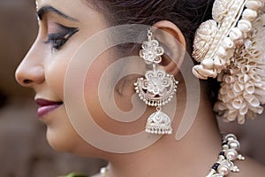 Close up face View of Beautiful indian odissi Dancer in traditional clothing with make-up and jewelry.