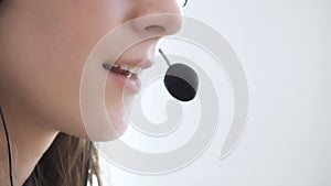 Close-up of the face of a young girl wearing headphones, who communicates online, explains, teaches.