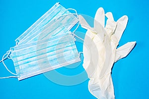Close-up of facemasks and a surgical glove