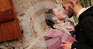 Close-up of the faces of a young couple in love kissing and hugging on the street