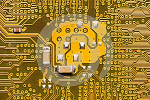 Close-up of a factory printed circuit board of electronics with pin tracks. Electronic background green tint