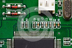 Close-up of a factory printed circuit board of electronics with pin tracks. Electronic background green tint