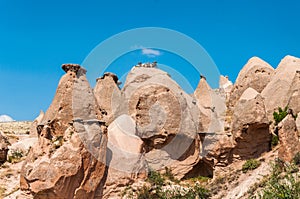 Close up fairy chimneys from Cappadocia. Impressive fairy chimneys of sandstone in the canyon near Cavusin village, Cappadocia