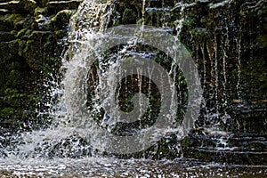 Closeup of falling and splashing streams of water, Ivande waterfall, Latvia