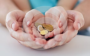 Close up of family hands holding euro money coins