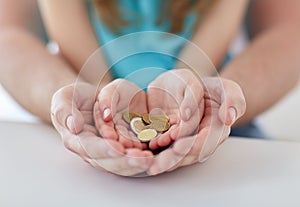 Close up of family hands holding euro money coins
