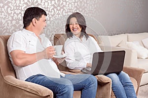 Close-up of family reading book and drinking tea