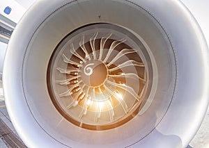 Close up of fan jet engine turbine with sunlight