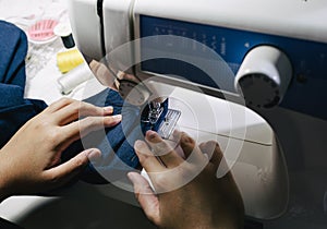 Close up fashion designer tailor clothing with sew equipment.