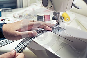 Close up fashion designer tailor clothing with sew equipment.