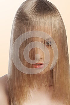 Close up of fashion girl covering face with hair