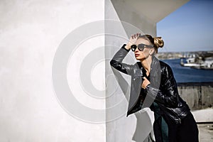Close up fashion ;luxury portrait of stunning woman, full perfect lips and face, sunny day sunglasses and leather jacket, big