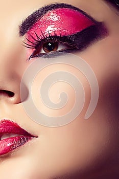 Close up fashion model portrait. Scarlet makeup. Black arrows.