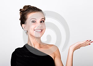 Close-up fashion photo young lady in elegant black dress, playful woman smiling and shows his hand