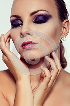 Close up fashion portrait. Model shooting. Purple makeup.