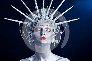 Close up fashion portrait of a woman with body paint looking like a Statue of Liberty