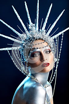 Close up fashion portrait of a woman with body paint looking like a Statue of Liberty