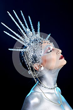 Close up fashion portrait of a woman with body paint looking like a Statue of Liberty