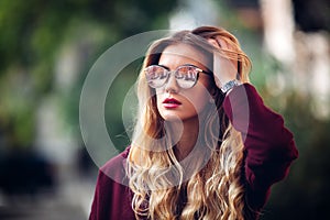 Close up fashion street stile portrait of pretty girl in fall casual outfit Beautiful blond posing outdoor.