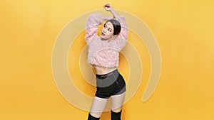 Close-up Fashion woman portrait of young pretty trendy girl posing against the backdrop of a yellow wall