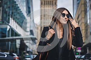 Close-up Fashion woman portrait of young pretty trendy girl posing at the city in Europe. Beautiful stylish woman in