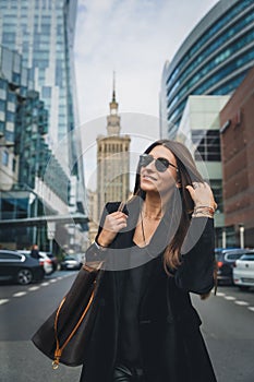 Close-up Fashion woman portrait of young pretty trendy girl posing at the city in Europe. Beautiful stylish woman in