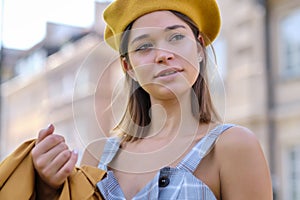 Close-up Fashion woman portrait of young pretty trendy girl posing at the city in Europe,summer street fashion, yellow beret ,