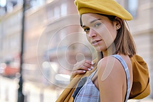 Close-up Fashion woman portrait of young pretty trendy girl posing at the city in Europe,summer street fashion, yellow beret ,