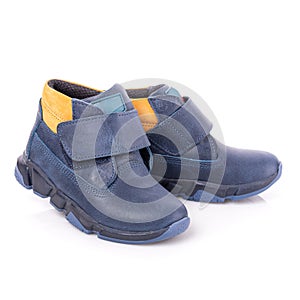 Close up of fashionable blue autumn velcro shoes for toddlers boys. Isolated on white background.