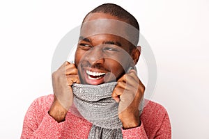 Close up fashionable young black man smiling with scarf against white background