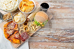 Close up of fast food snacks and drink on table