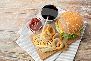Close up of fast food snacks and drink on table