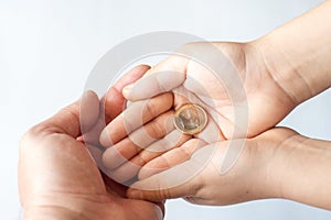 Close up of father and child hands holding euro money coins. Family, children, money, Investments, people concept