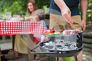 Close-up of father cooking BBQ